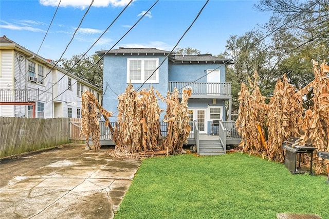 3415 Louisiana Ave Parkway, New Orleans, LA 70125 - back of property featuring stucco siding, a deck, fence, a patio, and a lawn