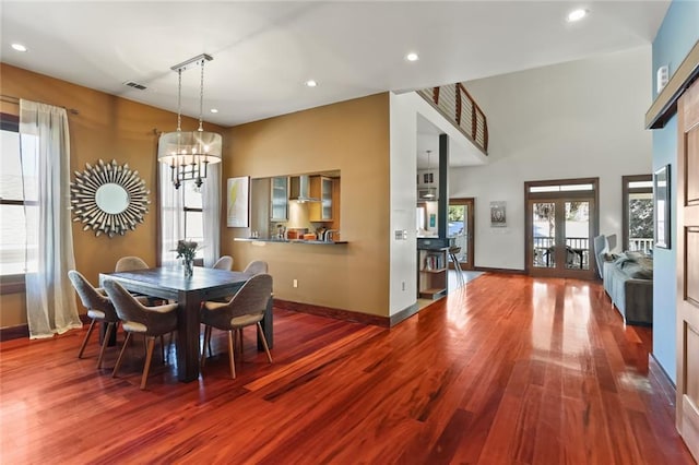 5533 Woodlawn Pl, New Orleans, LA 70124 - dining space featuring wood finished floors, a chandelier, plenty of natural light, and recessed lighting