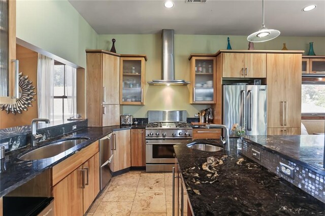 5533 Woodlawn Pl, New Orleans, LA 70124 - kitchen with appliances with stainless steel finishes, wall chimney range hood, a sink, dark stone countertops, and recessed lighting