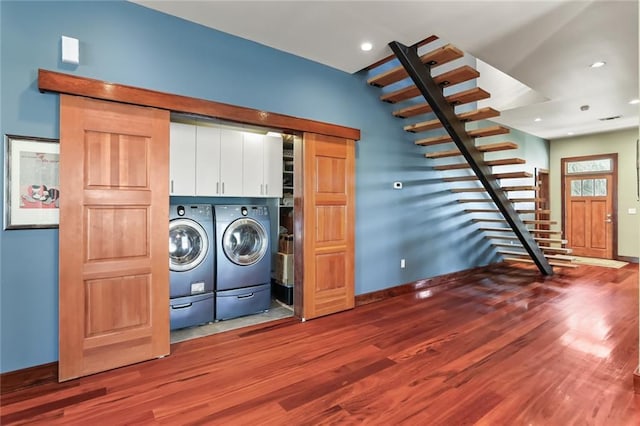 5533 Woodlawn Pl, New Orleans, LA 70124 - laundry area with cabinet space, washer and clothes dryer, wood finished floors, baseboards, and recessed lighting