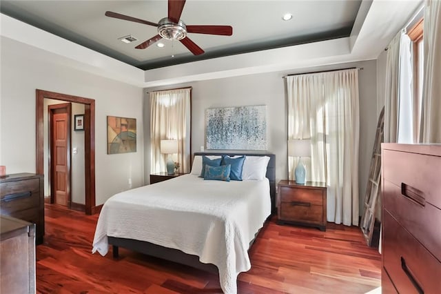 5533 Woodlawn Pl, New Orleans, LA 70124 - bedroom with a raised ceiling, wood finished floors, multiple windows, and recessed lighting