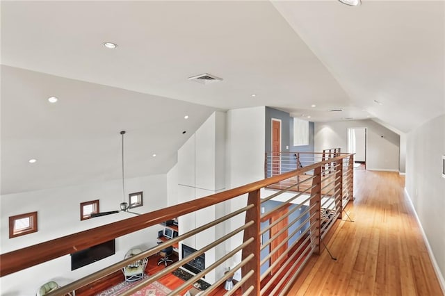 5533 Woodlawn Pl, New Orleans, LA 70124 - corridor featuring an upstairs landing, vaulted ceiling, light wood-type flooring, recessed lighting, and baseboards