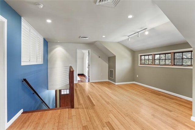 5533 Woodlawn Pl, New Orleans, LA 70124 - additional living space with baseboards, light wood finished floors, lofted ceiling, and recessed lighting