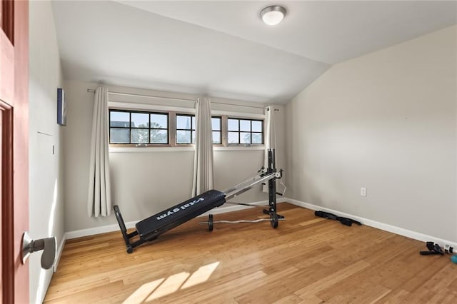 5533 Woodlawn Pl, New Orleans, LA 70124 - workout area featuring lofted ceiling, light wood-style flooring, and baseboards