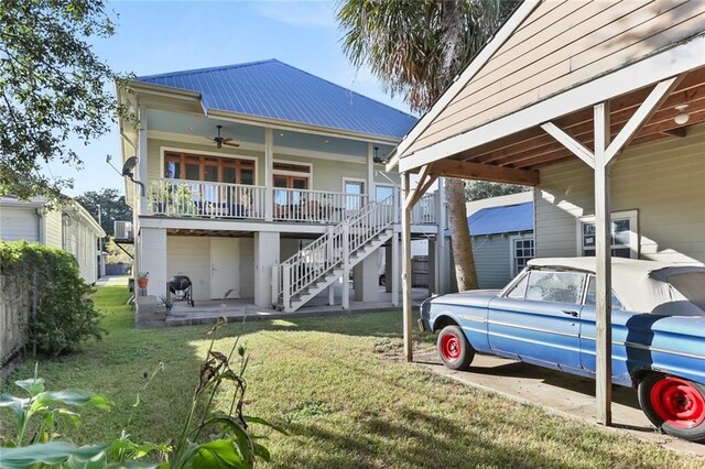 5533 Woodlawn Pl, New Orleans, LA 70124 - rear view of house with a yard, ceiling fan, metal roof, stairs, and covered porch