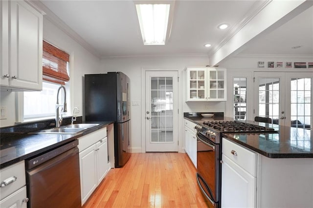 kitchen featuring dishwasher, gas range, white cabinetry, and french doors