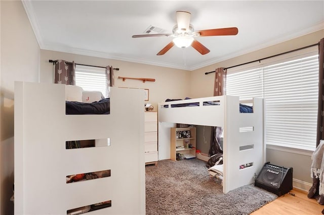 bedroom with ornamental molding, ceiling fan, and visible vents