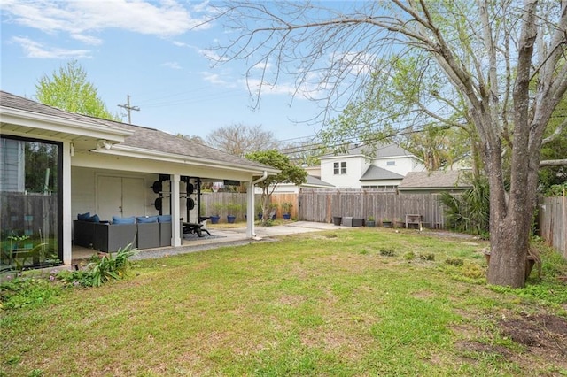 view of yard with an outdoor living space, a fenced backyard, and a patio area