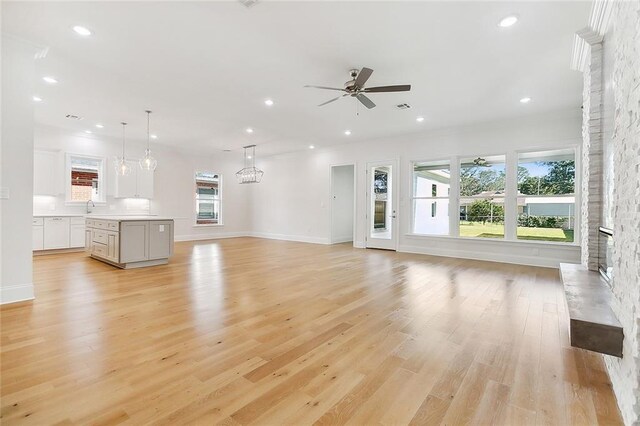 753 Jefferson Heights Ave, Jefferson, LA 70121 - unfurnished living room featuring ceiling fan, a sink, a fireplace, recessed lighting, and light wood-style floors