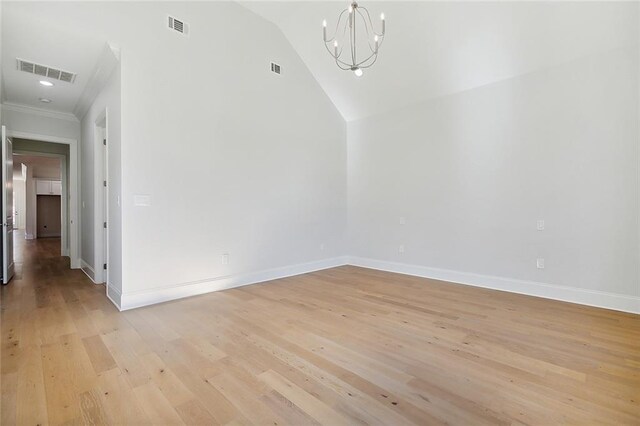 753 Jefferson Heights Ave, Jefferson, LA 70121 - empty room featuring a chandelier, light wood-style flooring, baseboards, vaulted ceiling, and crown molding