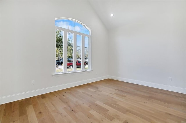753 Jefferson Heights Ave, Jefferson, LA 70121 - unfurnished room featuring baseboards, light wood finished floors, and high vaulted ceiling