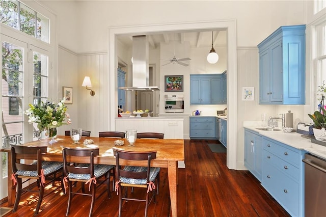 dining room with dark wood-type flooring and a ceiling fan