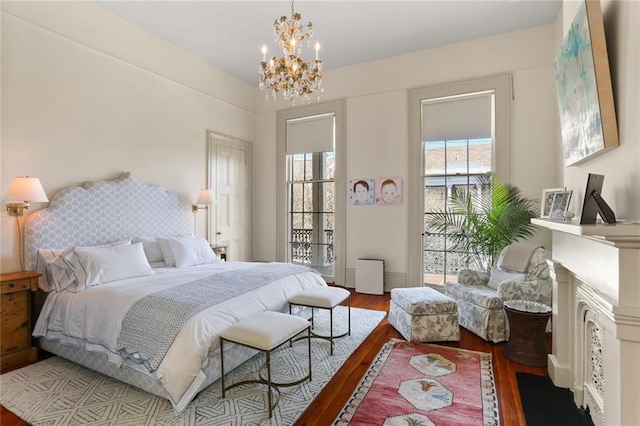 bedroom featuring a notable chandelier and wood finished floors