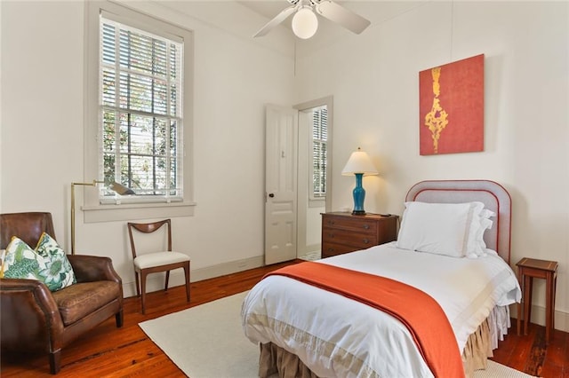 bedroom featuring baseboards, ceiling fan, and wood finished floors