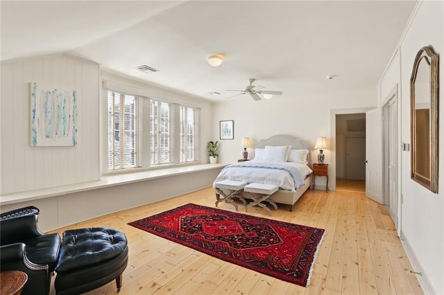 bedroom featuring vaulted ceiling, visible vents, a ceiling fan, and hardwood / wood-style floors