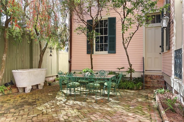 view of patio / terrace with entry steps, fence, and outdoor dining area