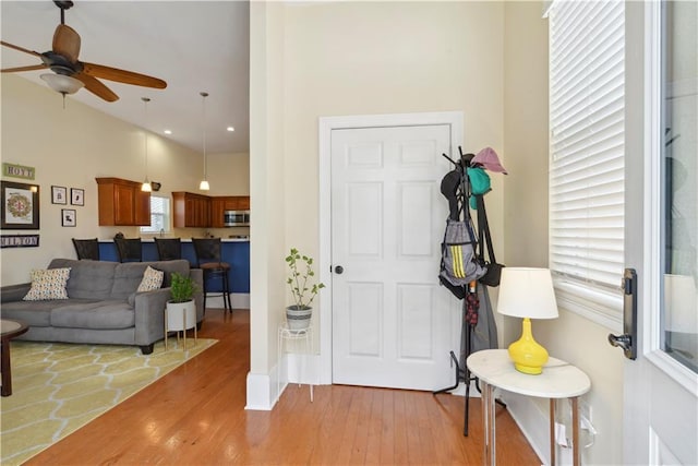 foyer entrance featuring light wood-style floors and ceiling fan