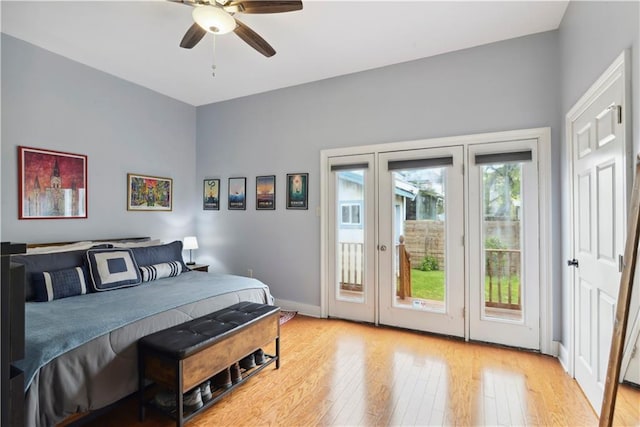 bedroom with baseboards, wood-type flooring, a ceiling fan, and access to outside