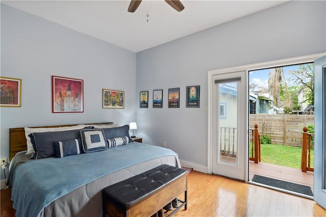 bedroom featuring hardwood / wood-style flooring, access to exterior, ceiling fan, and baseboards