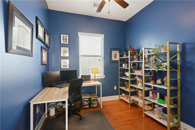 office featuring baseboards, visible vents, wood finished floors, and a ceiling fan