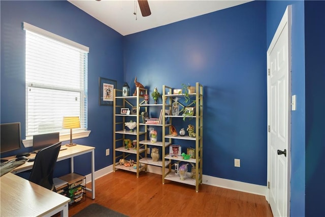 home office with baseboards, wood finished floors, and a ceiling fan