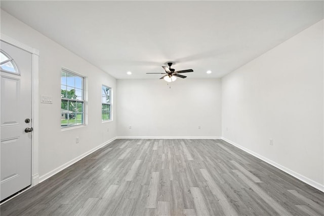 interior space featuring recessed lighting, baseboards, a ceiling fan, and wood finished floors