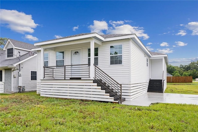 bungalow-style house featuring covered porch, stairway, and a front yard