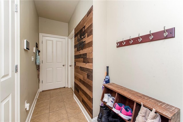 18201 Pine Ridge Dr, Prairieville, LA 70769 - doorway with light tile patterned flooring, wood walls, and baseboards