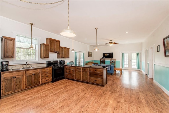 34310 Bluff Line Rd, Independence, LA 70443 - kitchen featuring open floor plan, black range with gas cooktop, french doors, dark countertops, and a peninsula