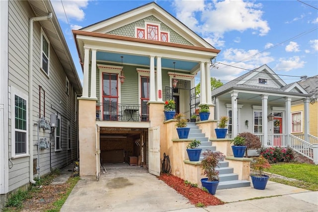 view of front of home featuring a porch and a garage