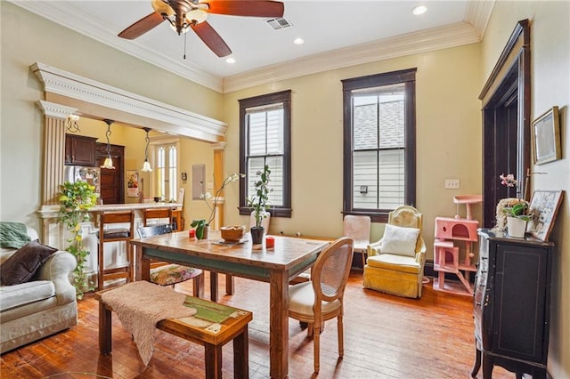 dining area with crown molding, a ceiling fan, light wood-type flooring, visible vents, and recessed lighting