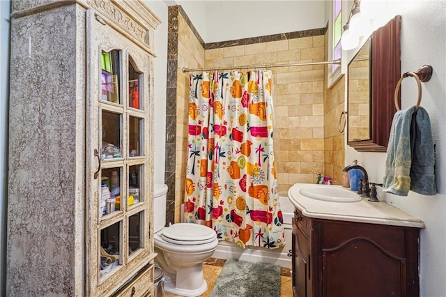 full bath with toilet, tiled shower, tile patterned flooring, and vanity