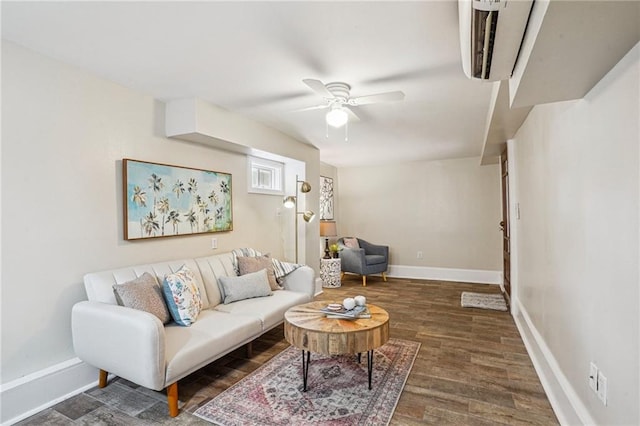 living area with a ceiling fan, baseboards, and wood finished floors