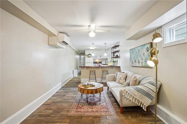 living room with baseboards, a wall mounted AC, dark wood-type flooring, and a ceiling fan