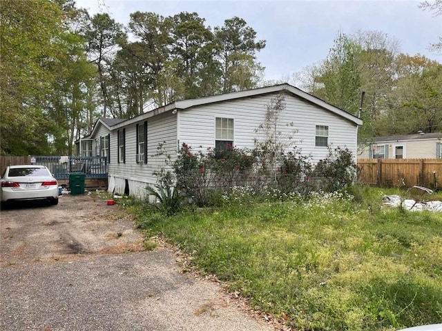view of side of property featuring fence