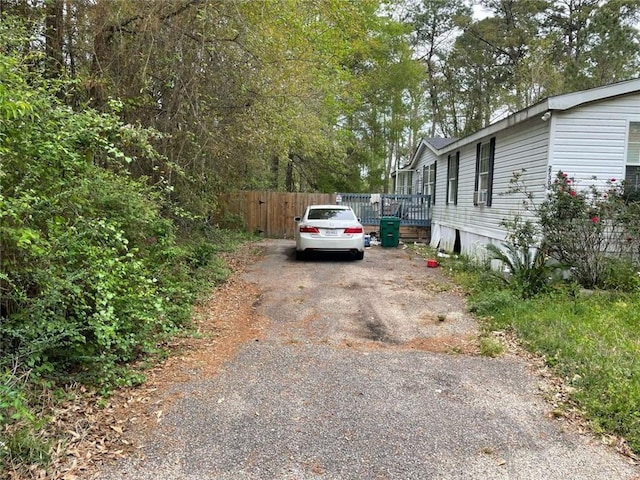 exterior space featuring fence and aphalt driveway