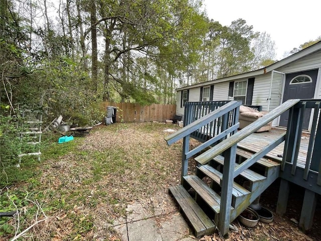 view of yard with fence and a deck