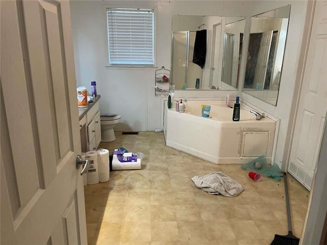 bathroom featuring toilet, visible vents, a shower stall, a garden tub, and vanity