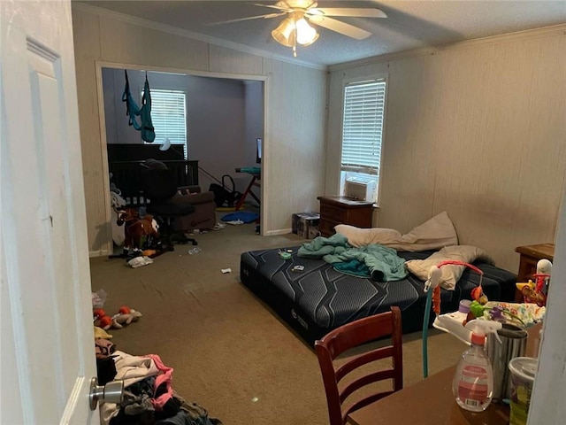 bedroom featuring carpet flooring, crown molding, and a ceiling fan