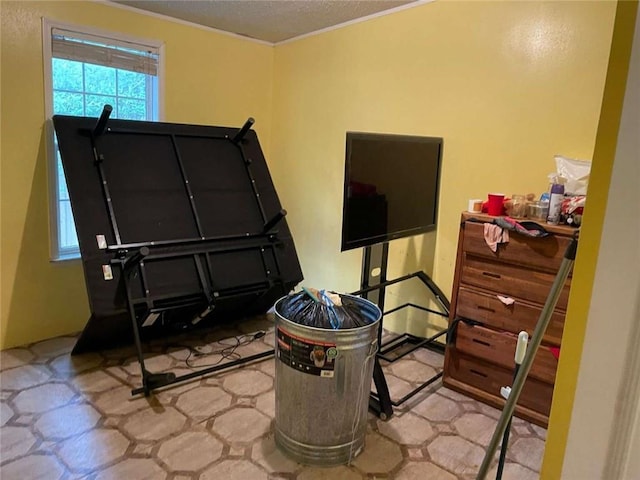 bedroom featuring a textured ceiling and ornamental molding
