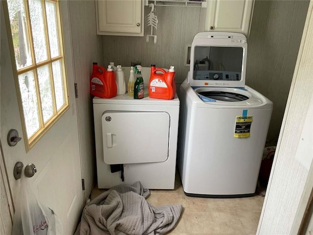 washroom with cabinet space and washer and dryer