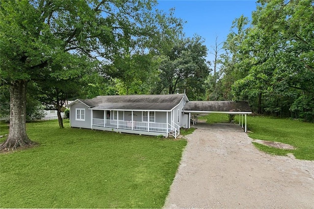 18155 La Highway 16, Denham Springs, LA 70726 - view of front of house featuring a front lawn, an attached carport, covered porch, and dirt driveway
