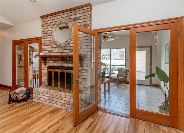 132 Country Club Dr, Covington, LA 70433 - living room with lofted ceiling, ceiling fan, wood finished floors, and a brick fireplace