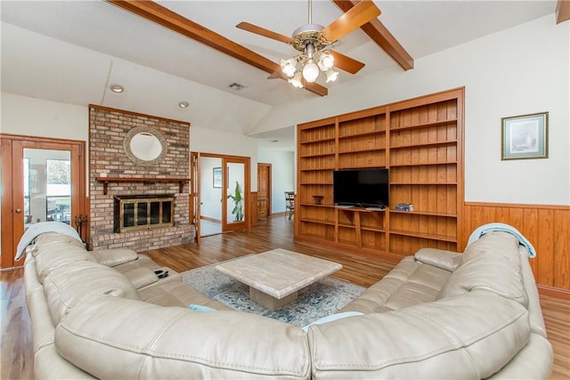 132 Country Club Dr, Covington, LA 70433 - living area featuring a ceiling fan, lofted ceiling with beams, a fireplace, and wood finished floors