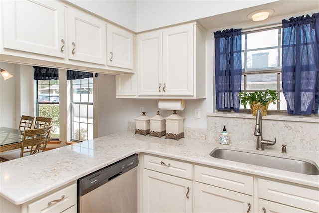 132 Country Club Dr, Covington, LA 70433 - kitchen featuring a peninsula, dishwasher, light stone countertops, white cabinetry, and a sink