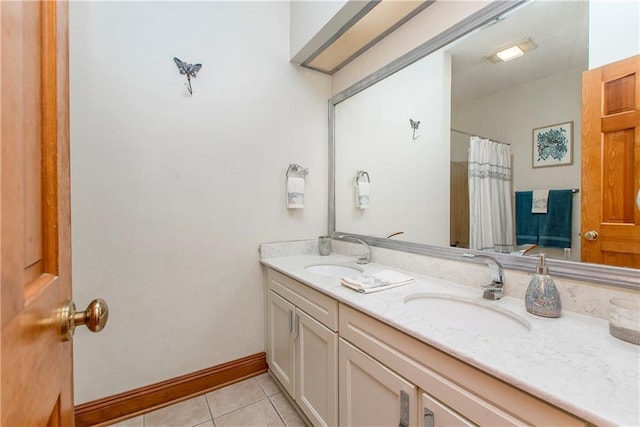132 Country Club Dr, Covington, LA 70433 - full bath with baseboards, double vanity, a sink, and tile patterned floors