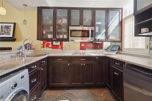 1040 Chartres St Unit D9, New Orleans, LA 70116 - kitchen featuring washer / dryer, stainless steel microwave, dishwasher, a sink, and light stone countertops