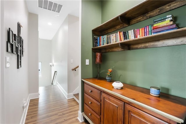 109 Moonlight Cove Ln, Luling, LA 70070 - hallway featuring an upstairs landing and light wood-type flooring
