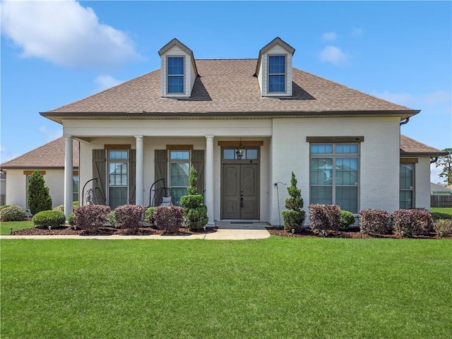 531 N Caleb Dr, Slidell, LA 70461 - view of front of home with a shingled roof, a front lawn, brick siding, and covered porch