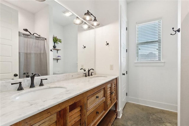 531 N Caleb Dr, Slidell, LA 70461 - bathroom with double vanity, toilet, and baseboards